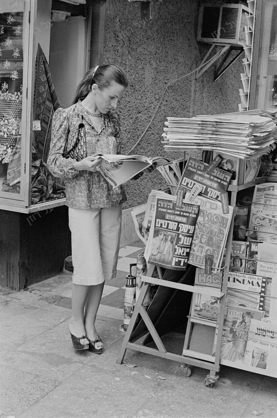 Flipping through magazines at the newsstand